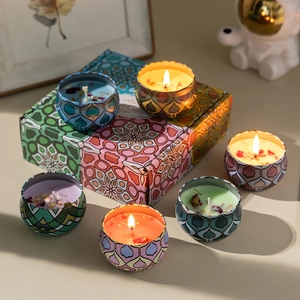 Detailed set of six colorful aromatherapy candles with dried flowers in a geometric gift box