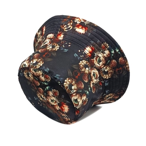 Close-up detail of vintage floral pattern and stitching on a black sun bucket hat