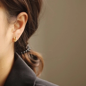 Elegant gold knot stud earrings for women in minimalist twisted metal design
