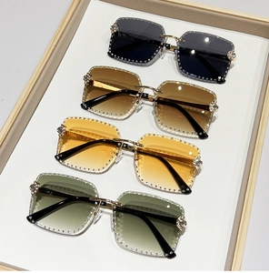 Detailed view of rimless square sunglasses with hand-set crystal rhinestones and floral hinges