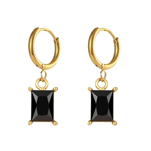 Detail of gold drop earrings featuring rectangular black faceted stones in four-prong setting