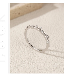 Detail shot of S925 sterling silver minimalist ring with cubic zirconia on stone background