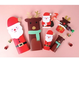 Detailed overhead view of Santa and reindeer paper gift boxes with festive ornaments