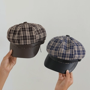Girl's plaid baker boy cap with leather brim in brown and navy checkered patterns