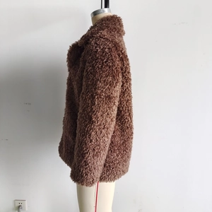 Side view of brown faux fur jacket showing plush texture and long sleeves on a mannequin