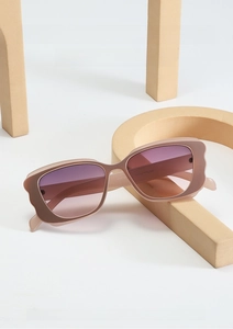 Detail of trendy butterfly sunglasses with beige frame and purple gradient lenses