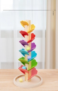 Detail of wooden rainbow music tree with colorful petals and marbles for kids