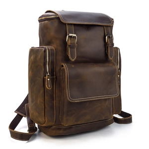 Side view of brown crazy horse leather backpack with vintage flaps and metal buckles