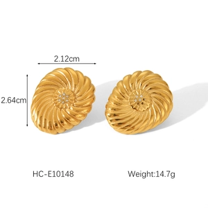 Macro view of 18K gold stainless steel earring with spiral texture and center diamond