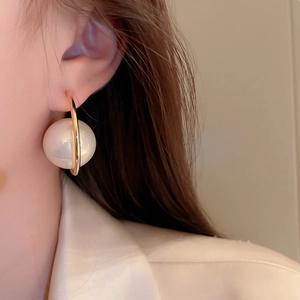 Chic gold C-shaped hoop earrings with a large white pearl bead for a minimalist look