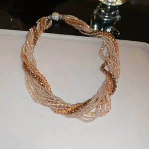 Detail of multi-strand twisted bead necklace in gold and champagne with magnetic clasp