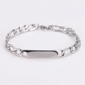Detail of silver stainless steel Figaro chain bracelet with smooth curved metal plate
