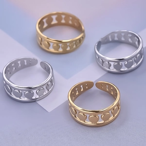 Detailed view of four adjustable hollow circular rings in gold and silver stainless steel