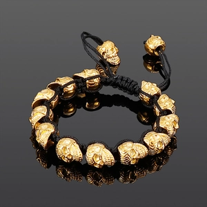 Retro punk black woven rope bracelet featuring golden titanium steel skull beads for men