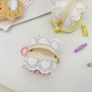 Close-up of cute plaid fabric earphone cases with lace trim and pearl charms
