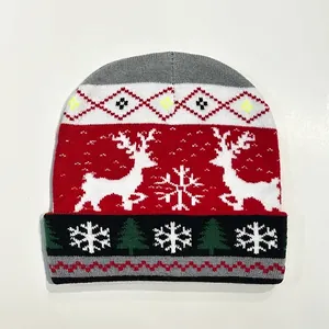 Close-up of knit Christmas beanie featuring reindeer and snowflake jacquard patterns