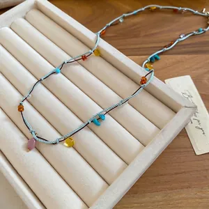 Bohemian double-layer woven necklace with turquoise beads on a jewelry display tray