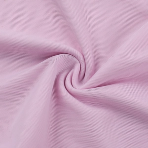 Close-up of pink mesh fabric showing breathable warp-knitted texture and soft draped folds