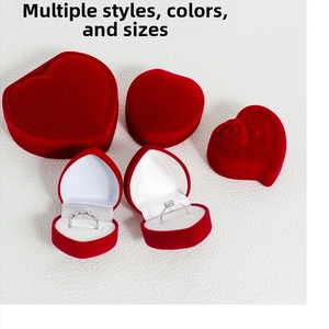 Detailed macro view of red heart shaped velvet jewelry boxes for rings and necklaces