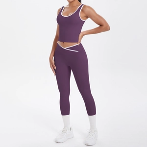 Detail of high-waist purple yoga leggings with white trim and V-shaped crossover waistband