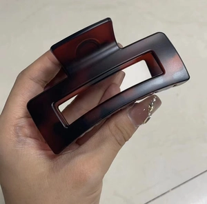 Macro detail of tortoiseshell pattern hair claw clip with rectangular hollow design