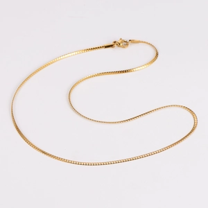 Detail of 2mm gold-plated snake chain necklace with lobster clasp for layering