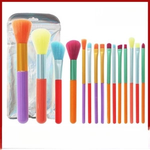Detail view of 13 colorful watercolor makeup brushes with vibrant bristles and a silver pouch