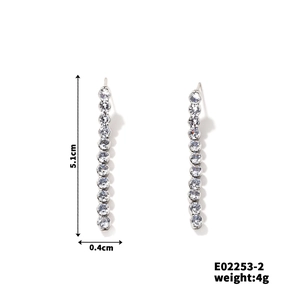 Macro shot of silver-toned drop earrings with full rhinestone tassels, 5.1cm length