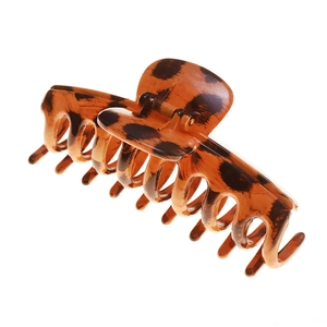 Minimalist tortoiseshell hair claw clip for women featuring a stylish ink splatter pattern