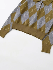 Close-up of diamond pattern polo knitwear featuring olive green tones and ribbed cuffs