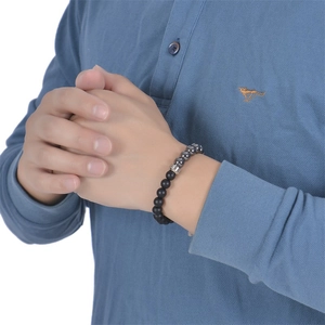Men's 8mm map stone beaded bracelet with stainless steel accents on a model's wrist