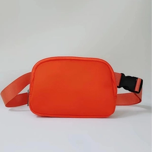 Waterproof athletic fanny pack in bright orange with adjustable strap and buckle