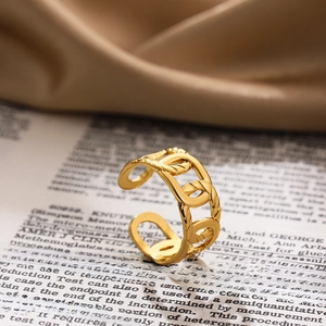 Detailed close-up of a 18K gold hollow chain ring on vintage book background