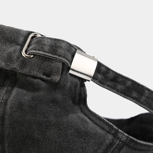Detailed close-up of adjustable metal buckle and stitching on washed denim brimless hat