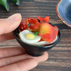 Handheld realistic miniature Japanese udon noodle bowl model with egg and octopus