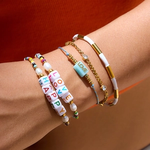 Colorful resin LOVE alphabet bead bracelets layered set for women on model wrist