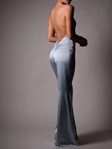 Detailed view of the backless satin jumpsuit with criss-cross thin straps and drape finish