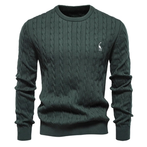 Close-up of dark green cable knit sweater featuring white giraffe embroidery detail