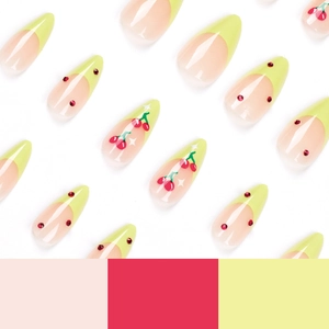 Almond shaped press-on nails with green French tips, cherry patterns and red rhinestones