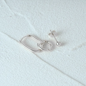 Macro shot of S925 sterling silver stamp on minimalist turquoise earring set