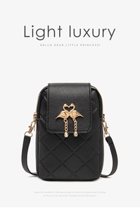 Macro detail of quilted black leather cross-body phone bag with golden swan closure