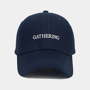 Detail of GATHERING embroidery on dark blue cotton twill baseball cap with curved brim