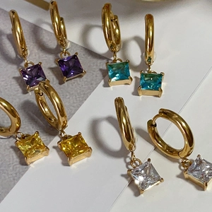 Macro shot of 18k gold plated hoop earrings with square cubic zirconia in various colors
