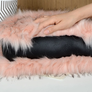 Detail of pink long plush and black leather texture on a premium car armrest box pad
