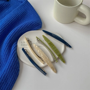 Elegant resin hair clips in olive green, navy, and beige with a chic pearlescent finish