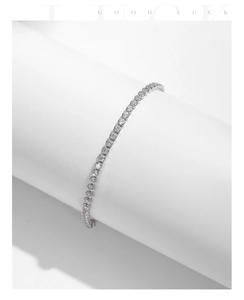 Detailed view of s925 silver tennis bracelet with sparkling round-cut zircon on white stand
