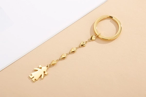 Close-up of golden stainless steel keychain featuring a heart link chain and girl pendant