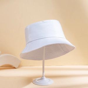 Minimalist white cotton bucket hat displayed on a stand with high texture detail