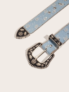Detail of blue denim belt with metal beads, sequins and vintage engraved buckle