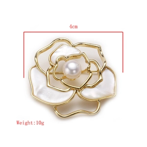 Detail shot of camellia flower brooch with pearl center and 4cm size measurement text